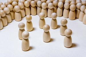 follow the leader or human resource management concept. crowd of wooden people photo