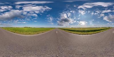 Full spherical seamless hdri panorama 360 degrees angle view on no traffic asphalt road among fields with clear blue sky and beautiful clouds in equirectangular projection, VR AR content photo