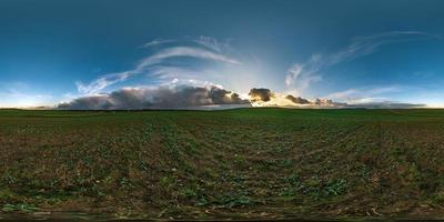 full seamless spherical hdr panorama 360 degrees angle view among fields with awesome black clouds before storm in equirectangular projection, VR AR virtual reality content with zenith photo