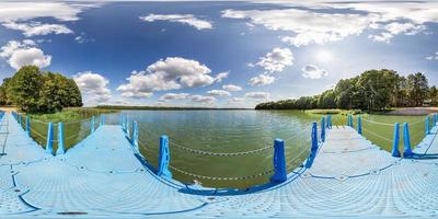 full seamless spherical hdri panorama 360 degrees  angle view on blue plastic pier of huge lake or river in sunny summer day with beautiful clouds in equirectangular projection, VR content photo