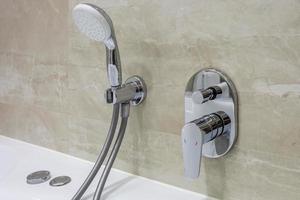 detail of a corner shower cabin with wall mount shower attachment photo