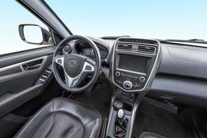 panorama in interior leather salon of prestige modern car. steering wheel, shift lever and dashboard photo