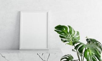 Empty photo frame mockup on white marble table with swiss cheese plant foreground on concrete background. Art and interior home decoration concept. 3D illustration rendering