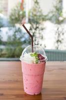 Strawberry smoothies summer strawberry with leaf of mint on wooden table. Fresh fruits photo