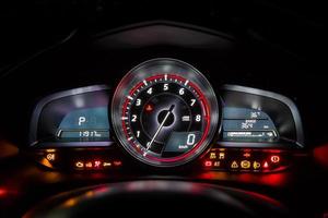 Modern car instrument dashboard panel or speedometer and full symbol in night time photo