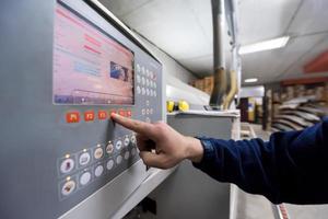 carpenter calculating and programming a cnc wood working machine photo