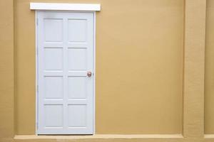 White door classic vintage on the color yellow wall background photo