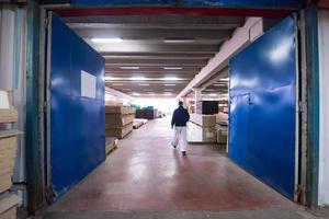 carpenter walking through factory photo