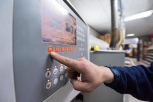 carpenter calculating and programming a cnc wood working machine photo