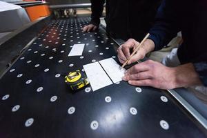 carpenters calculating and programming a cnc wood working machine photo