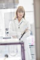 female researcher holding up a test tube in lab photo