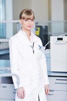 female researcher holding up a test tube in lab photo