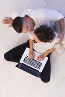 couple using tablet and laptop computers top view photo