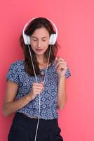 woman with headphones isolated on a red photo