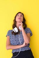 woman with headphones isolated on a yellow photo