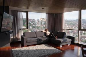 mujer usando tableta en hermoso apartamento foto