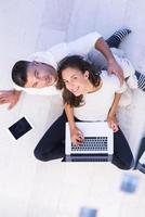 couple using tablet and laptop computers top view photo