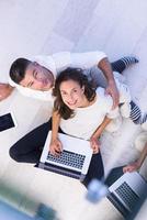 couple using tablet and laptop computers top view photo