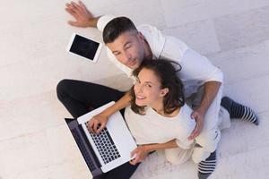 couple using tablet and laptop computers top view photo