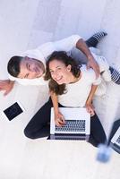 couple using tablet and laptop computers top view photo