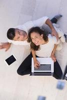 couple using tablet and laptop computers top view photo