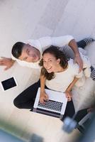 couple using tablet and laptop computers top view photo