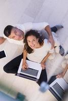 couple using tablet and laptop computers top view photo