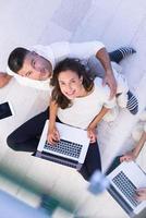 couple using tablet and laptop computers top view photo