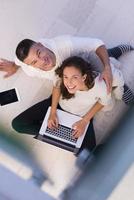 couple using tablet and laptop computers top view photo