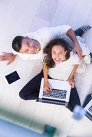 couple using tablet and laptop computers top view photo