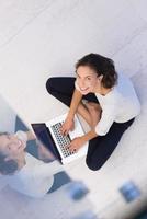 women using laptop computer on the floor top view photo