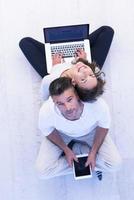 couple using tablet and laptop computers top view photo