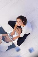 women using laptop computer on the floor top view photo