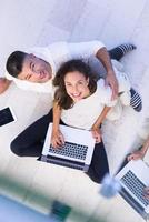 couple using tablet and laptop computers top view photo