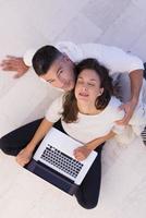 couple using tablet and laptop computers top view photo