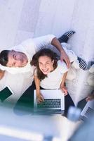 couple using tablet and laptop computers top view photo