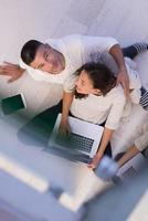 couple using tablet and laptop computers top view photo