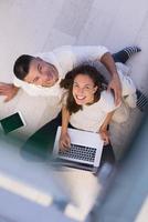 couple using tablet and laptop computers top view photo