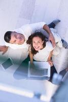 couple using tablet and laptop computers top view photo