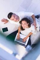 couple using tablet and laptop computers top view photo