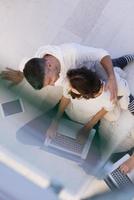 couple using tablet and laptop computers top view photo