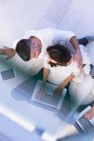 couple using tablet and laptop computers top view photo