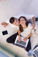 couple using tablet and laptop computers top view photo