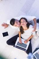 couple using tablet and laptop computers top view photo