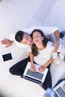 couple using tablet and laptop computers top view photo