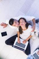 couple using tablet and laptop computers top view photo
