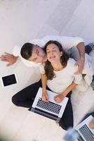 couple using tablet and laptop computers top view photo