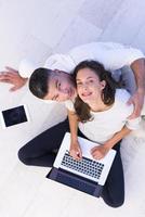 couple using tablet and laptop computers top view photo