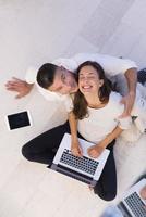 couple using tablet and laptop computers top view photo