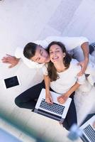 couple using tablet and laptop computers top view photo